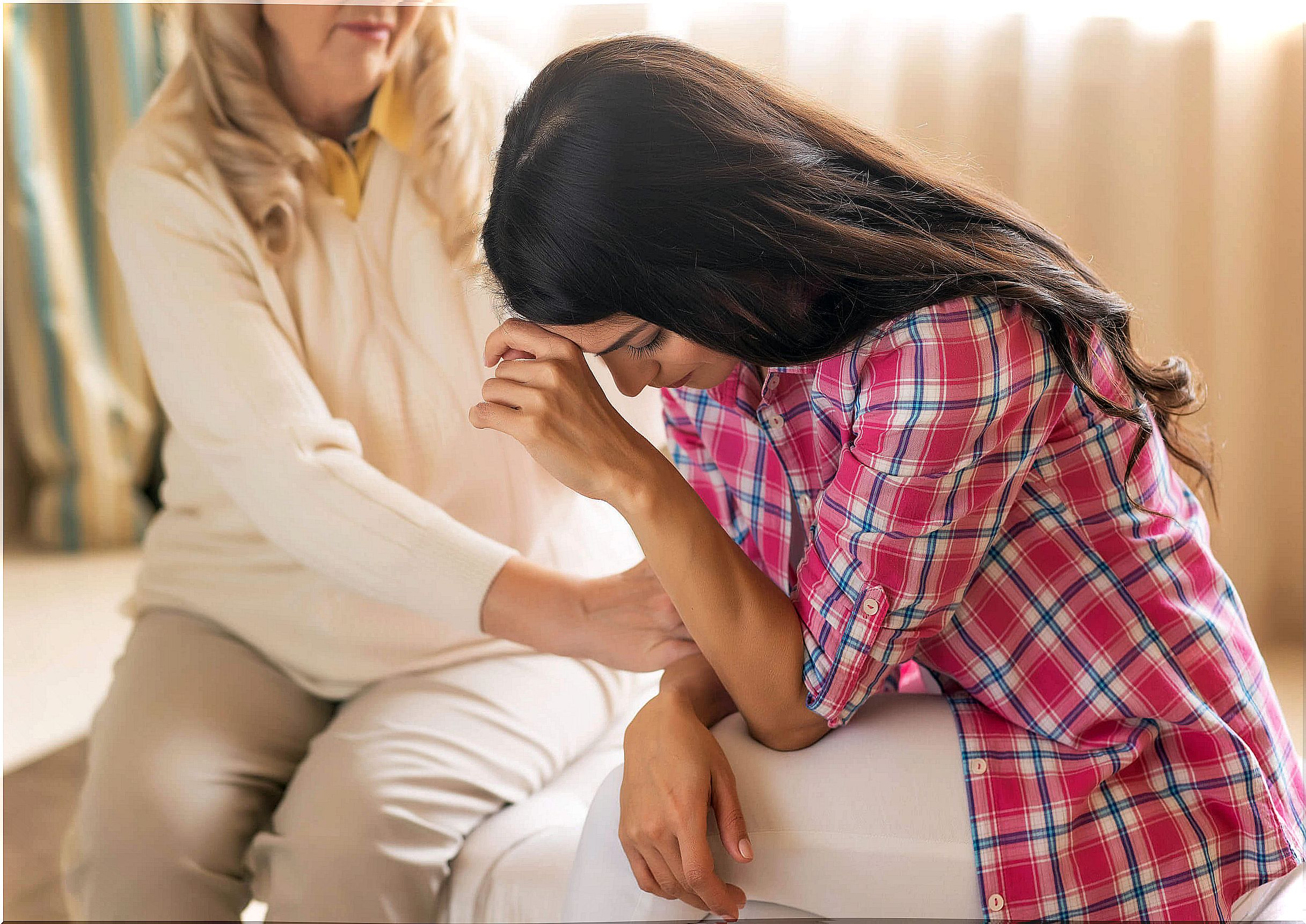 Mother supporting her daughter as she goes through perinatal grief after losing her baby.