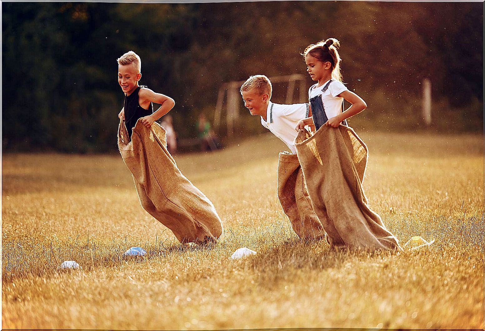 Boy doing a sack race, one of the fun sports activities for kids.