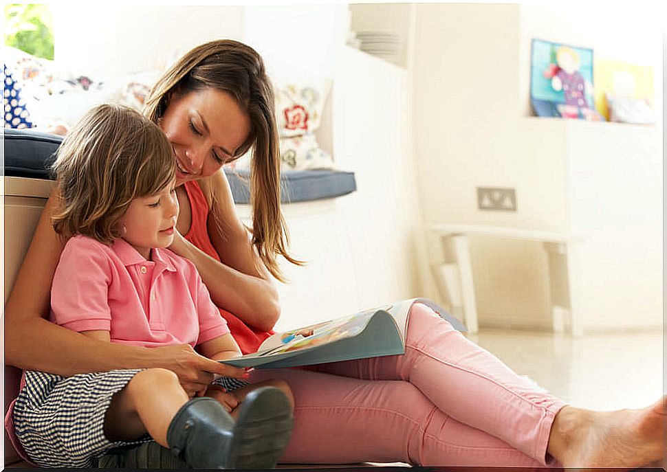 Mom reading with her son bilingual children's books to learn English.