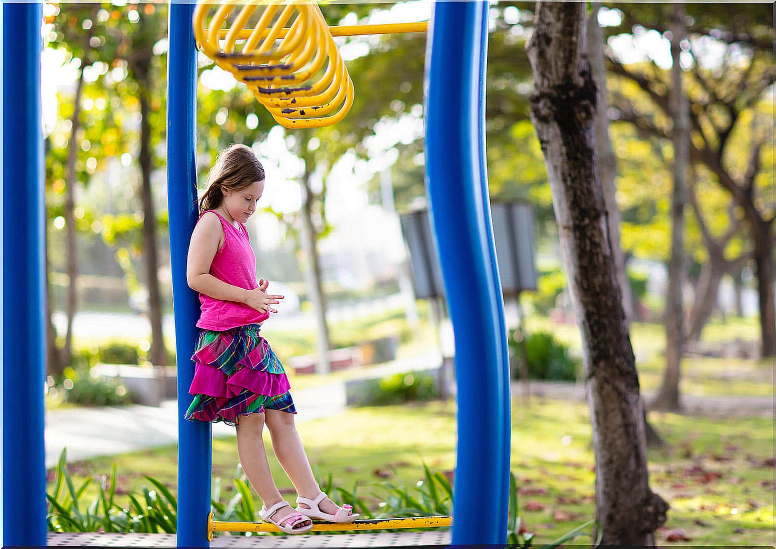 Girl playing alone in the park.