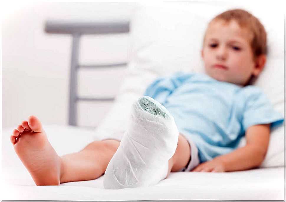 Child in bed with leg in cast.