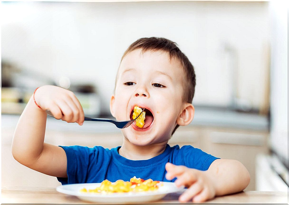 Child eating all the food on the plate.