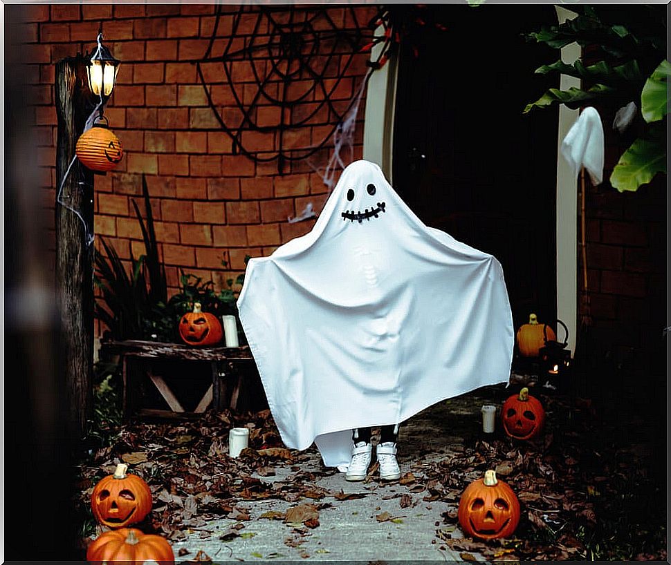 Child dressed as a ghost for Halloween.