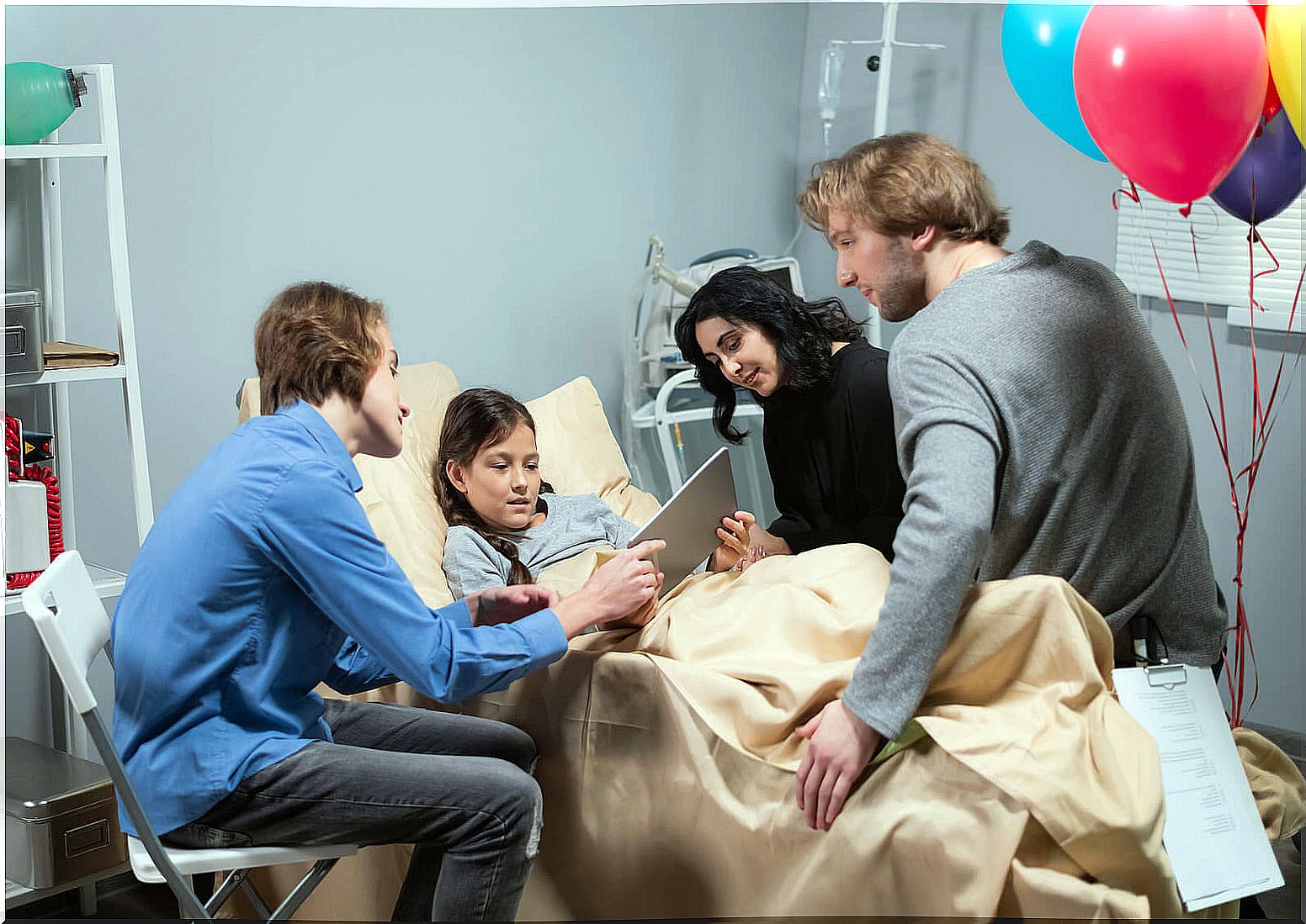 Sick girl receiving a visit from her family in the hospital.