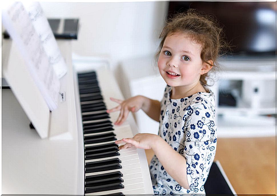 Girl playing the piano to develop her talent.