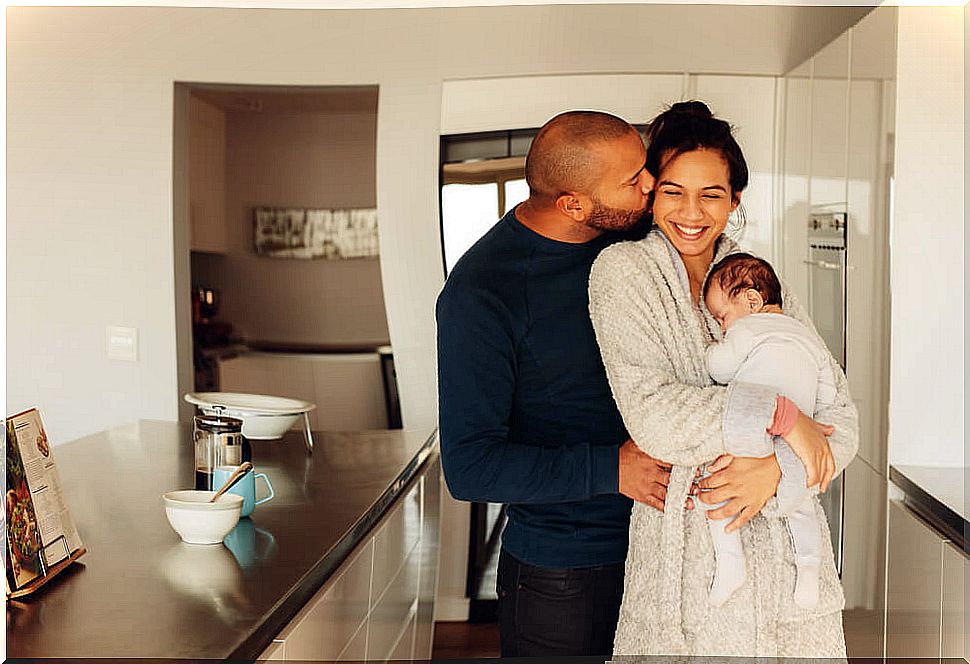 Parents hugging their newborn child and experiencing increased levels of oxytocin, the happiness hormone.