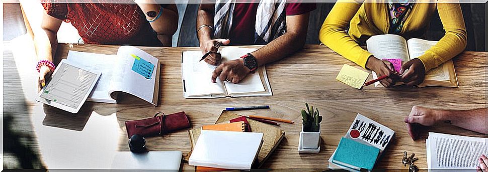 Teens studying and reading to expand vocabulary in high school.