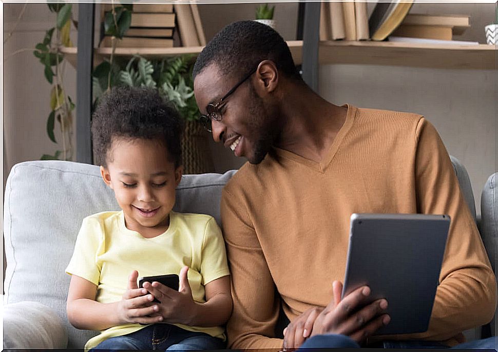 Father with his son teaching him good use of new technologies.