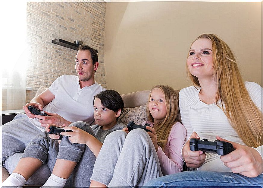 Parents with their children playing video games.