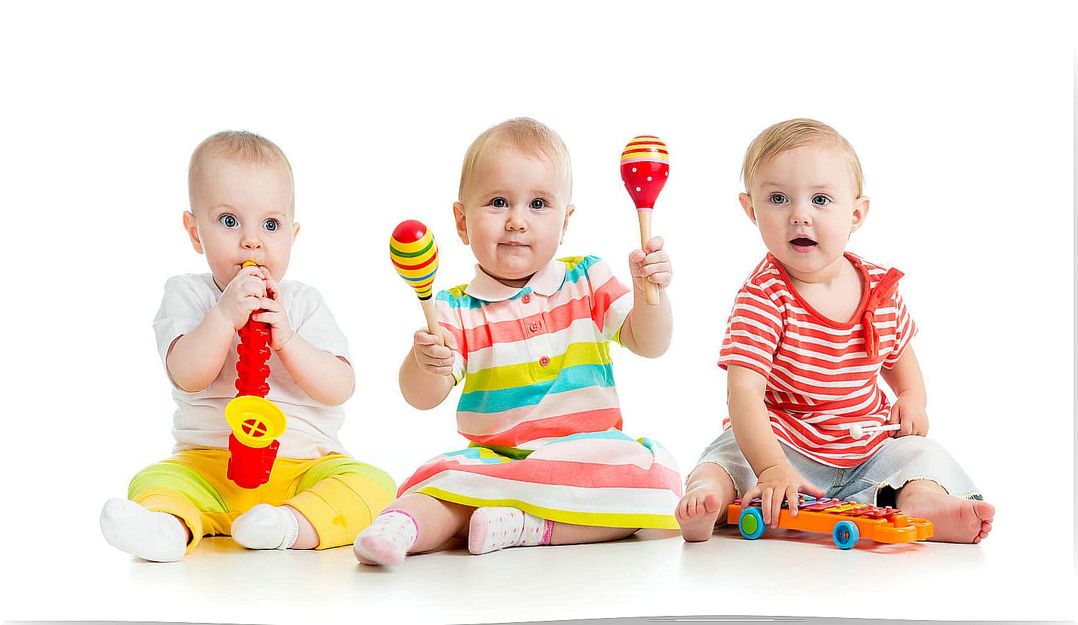 Babies playing with musical objects