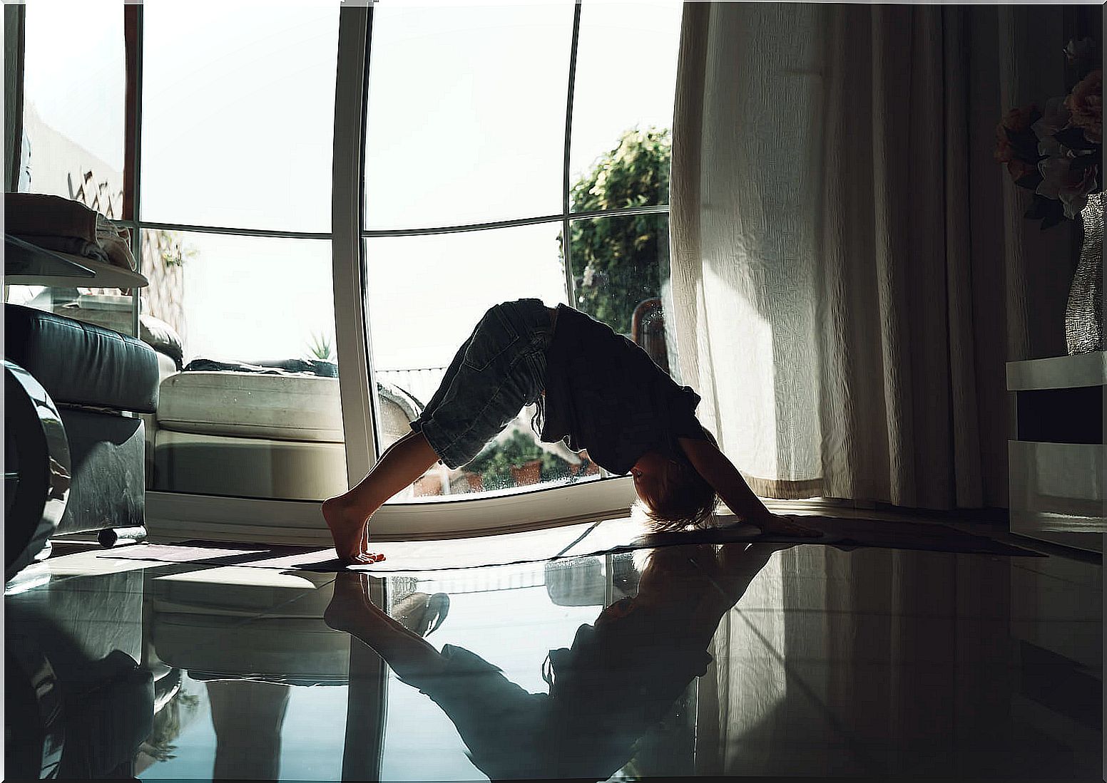 Boy doing a yoga posture as part of his meditation.