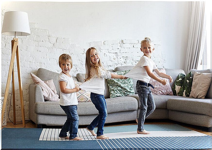 Children playing in the living room at home.