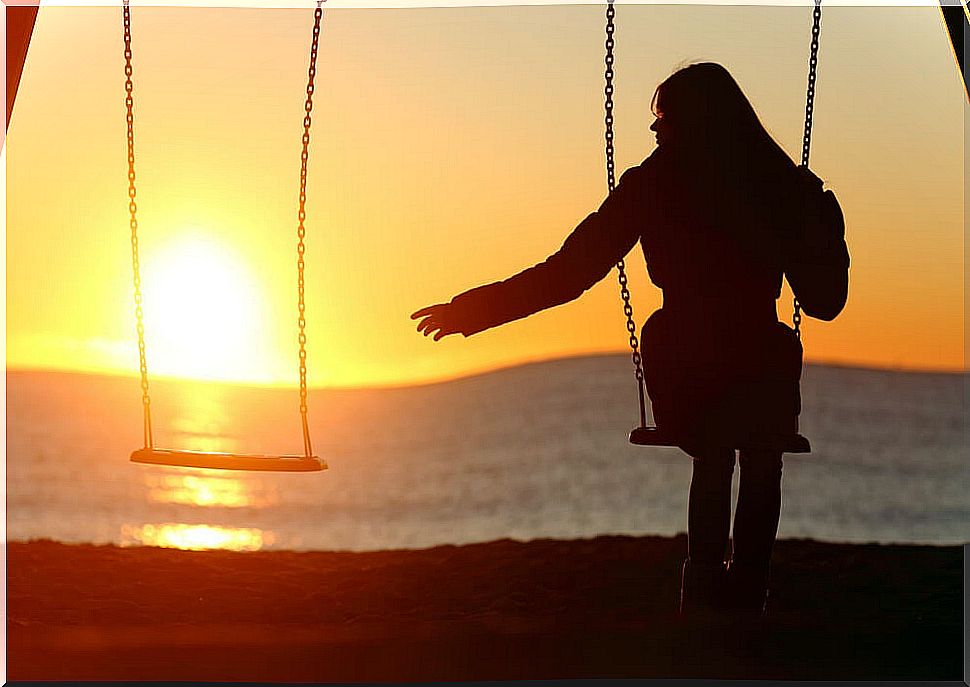 Widowed woman alone on a swing thinking about the widow's pension.